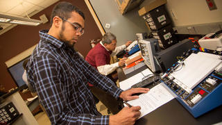 student writing notes in a lab