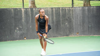 A NCCU tennis player preparing to serve