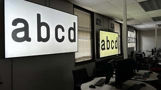 A graphic design classroom displaying different text options on screens