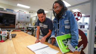 Students looking at a notebook together