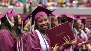 Graduate poses with degree