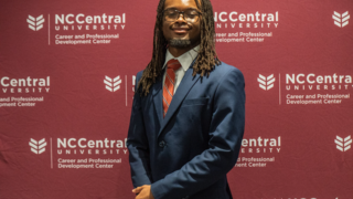 Male student in a suit.