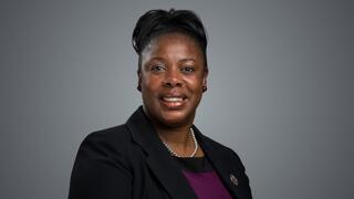 Dr. Sharon Oliver in black blazer