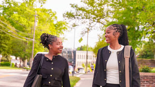 Business students walking together, smiling