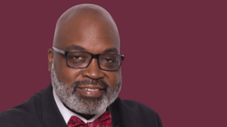 James Ham in front of a maroon background