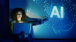 Lady with laptop pointing to AI