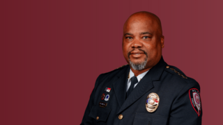 Chief Gaddy in police dress uniform maroon background
