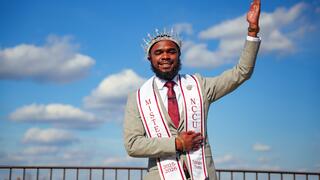 Christopher Thorns smiling and waving.