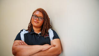 Alexandria Wiggins with black shirt and arms folded across chest