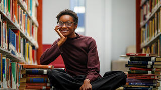 Haley Moore sitting in library against books