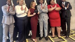 Dr. Angela A. Coleman smiling with students.