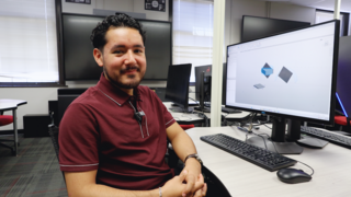 Zamir Vazquez sits in front of computer