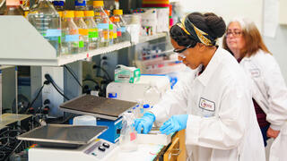 NCCU faculty researcher and student in white coats