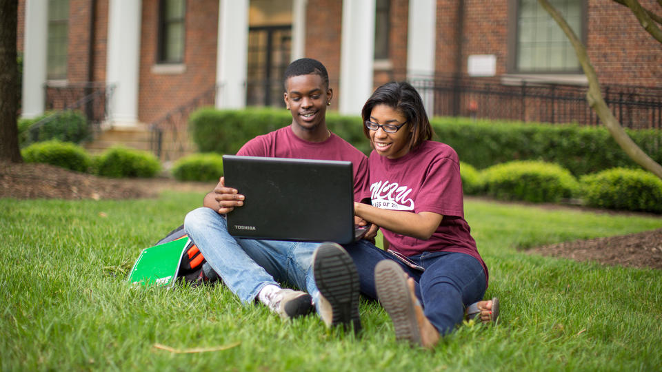 Two Students Outside with Computer