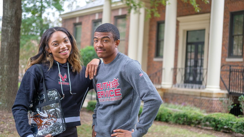 Two students standing outside.