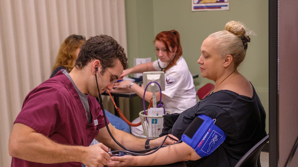 Student with patient in labs.