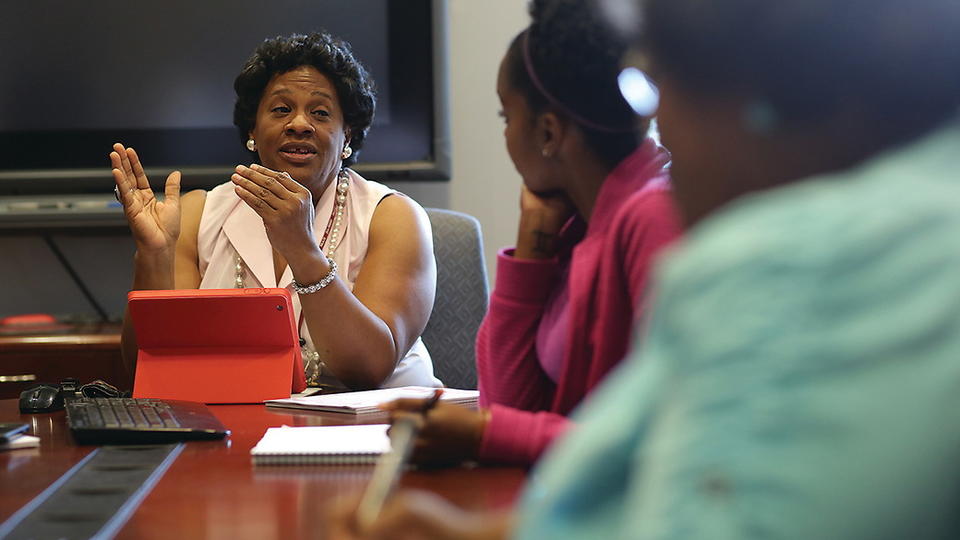 Mildred Pointer, who is a co-principal investigator on an NIH grant on health disparities, and who is researching the causes and treatments of hypertension, leads a planning meeting with students and researchers for an upcoming population study. 