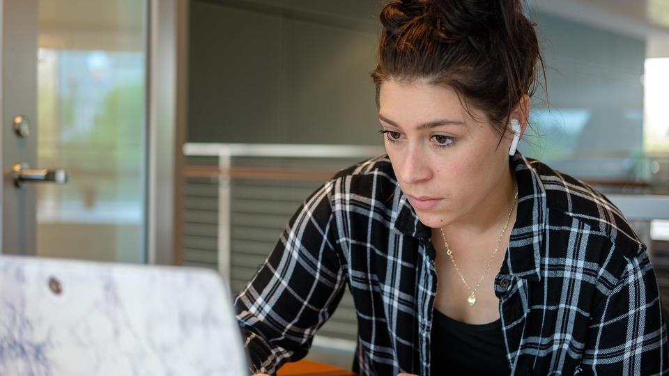 Student reading something off a laptop