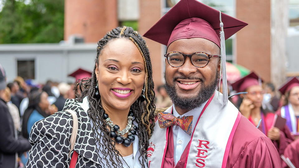 Students in cap and gown, with his mother