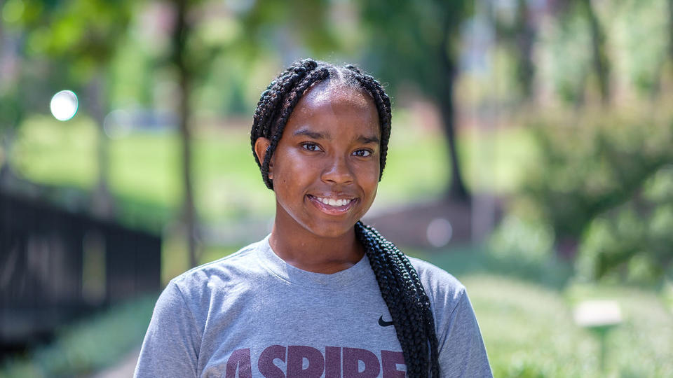 Student smiling wearing a shirt with the words "Aspiring Eagle"