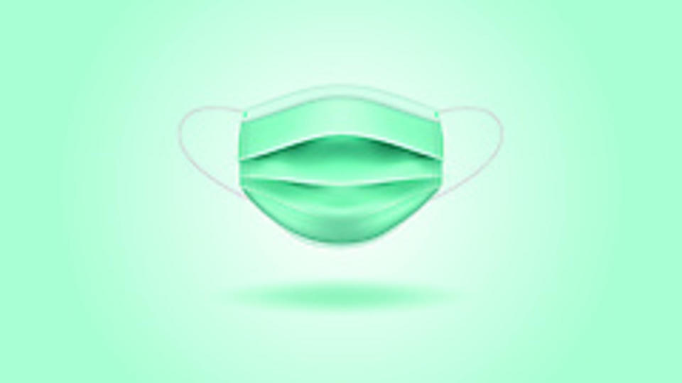 A surgical mask before a green background