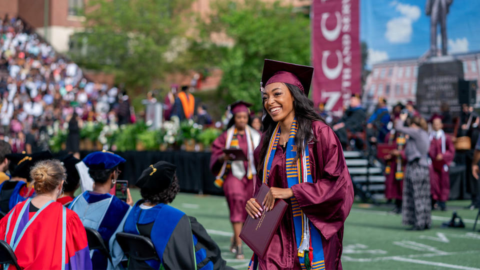 graduate walking back to seat after receiving diploma