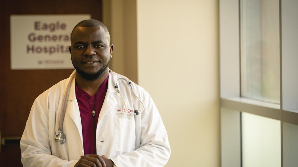 Nursing Graduate Sheriff Mansaray in front of Eagle General Hospital 