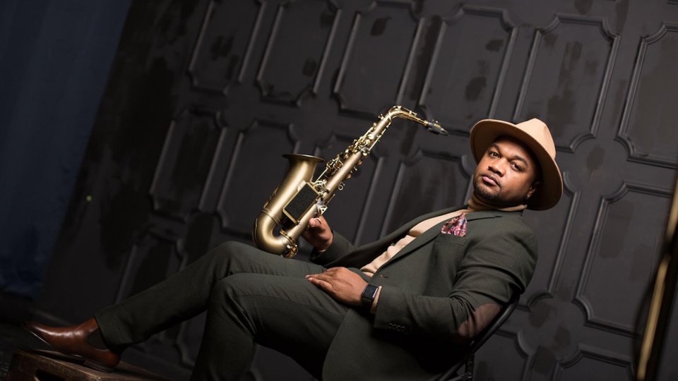 Marcus Anderson sitting with saxophone