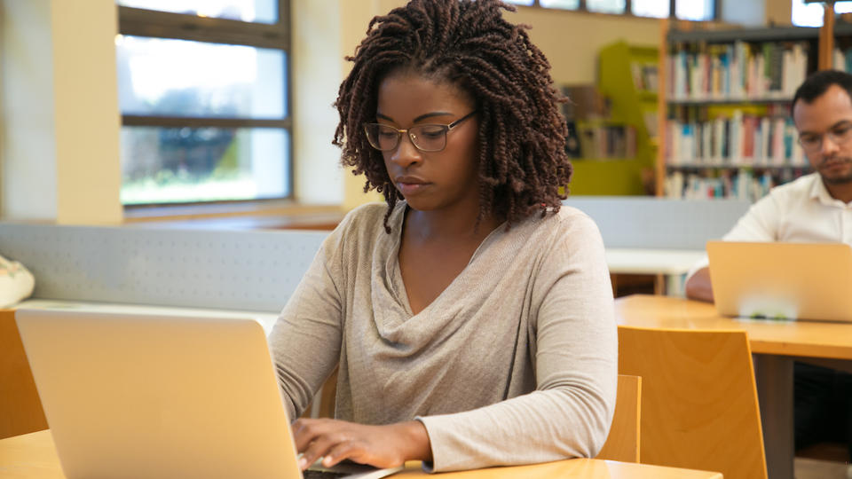 Professional student focused on her laptop