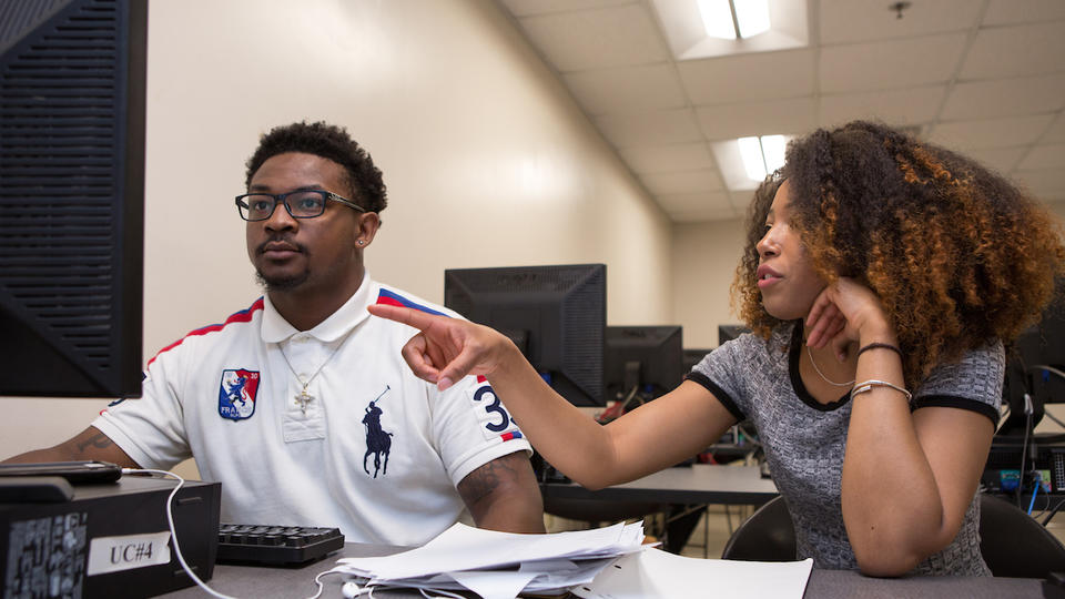 Two people looking at computer screen