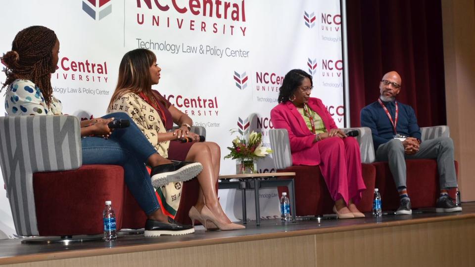 four panelists speaking on stage