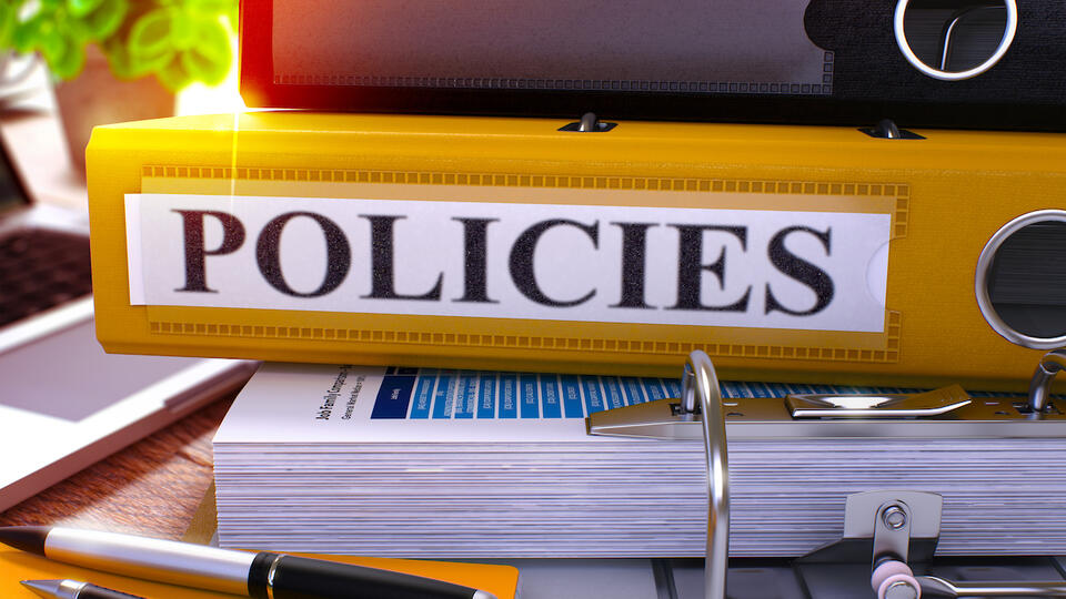 Stock image of policies notebooks on a desk