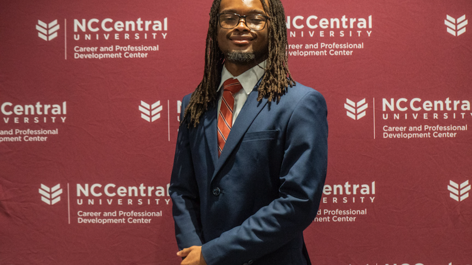 Male student in a suit.