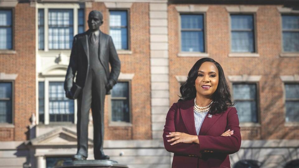 Chancellor Dixon standing beside Dr. Shepard statue