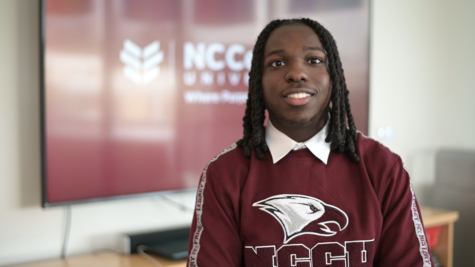 Edmund Rhynes Jr. smiles in an NCCU Eagles shirt