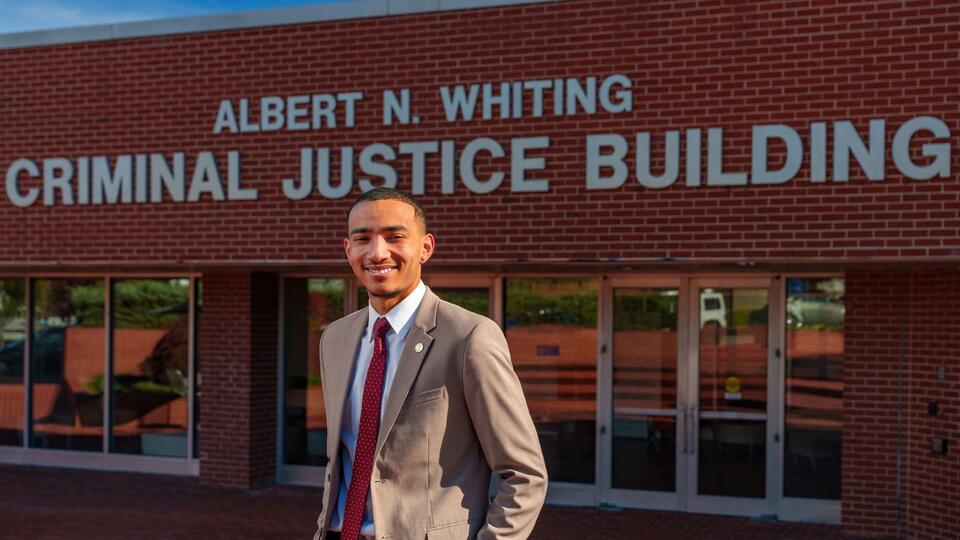 african american male student, standing in front of the criminal justice building on NCCU campus