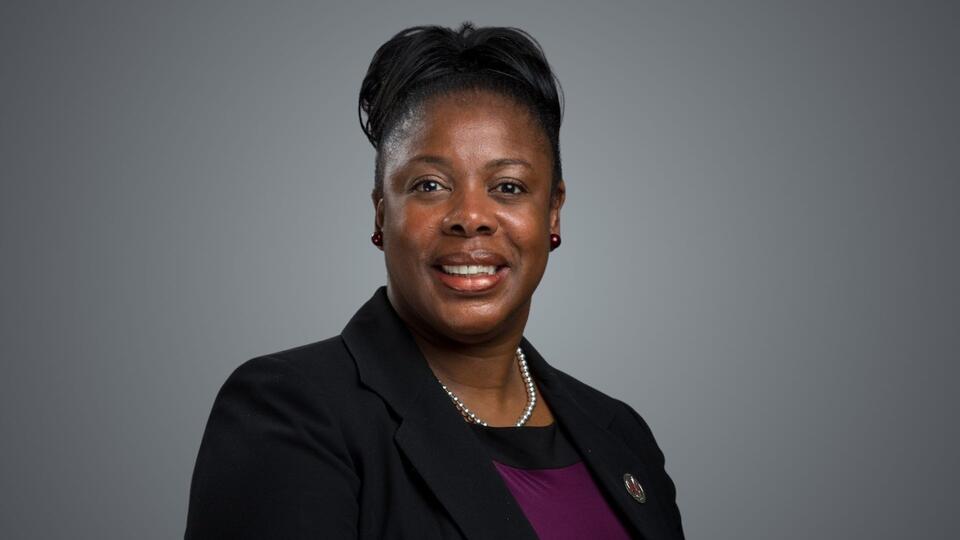 Dr. Sharon Oliver in black blazer