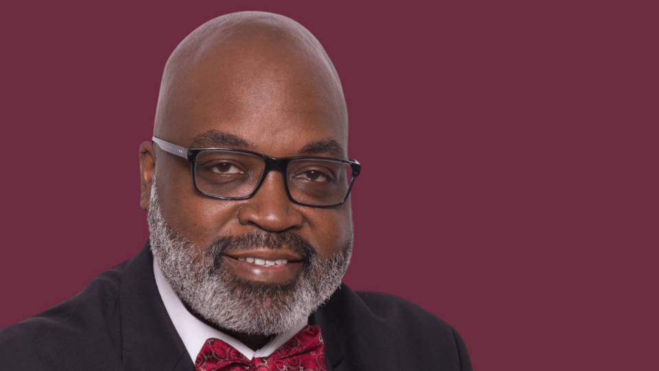 James Ham in front of a maroon background