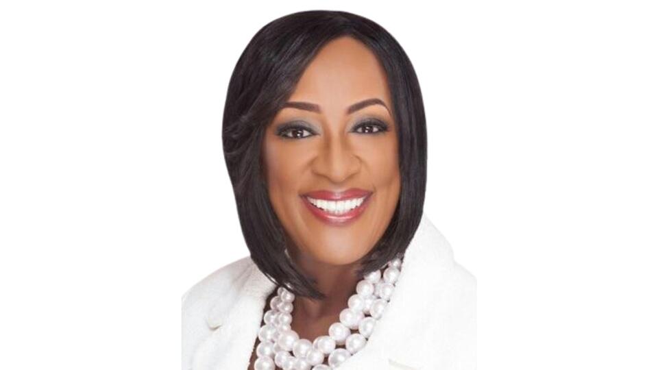 Professional portrait of Gwendolyn Boyd smiling, wearing a white blazer and pearl necklace against a clean white background.