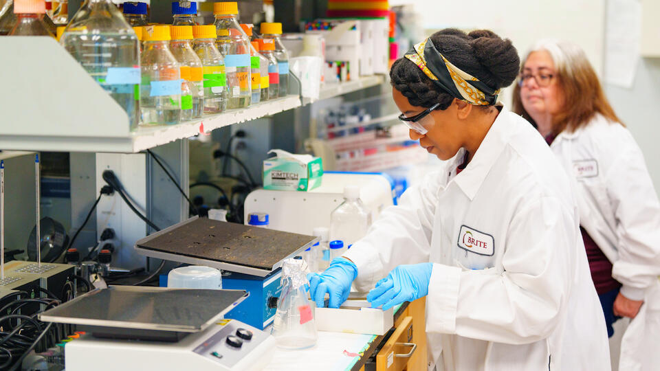 NCCU faculty researcher and student in white coats
