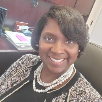 Akua Johnson Matherson sitting in desk chair