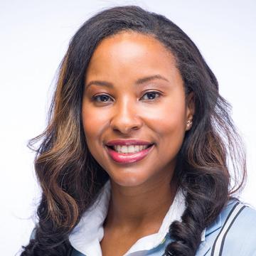 Young African American woman with long brown hair and blue coat.