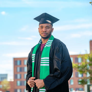 Graduate student standing outside.
