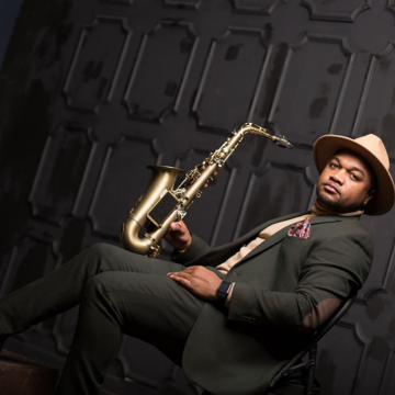 Marcus Anderson sitting with saxophone
