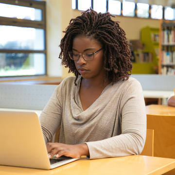 Professional student focused on her laptop