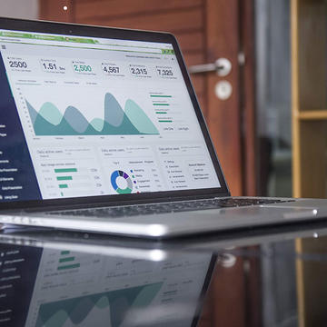 Laptop on a table with statistics on the screen