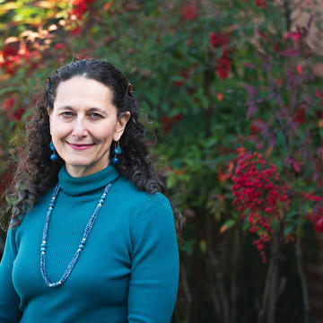 Dr. Rachelle Gold standing in front of flowers