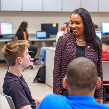 Chancellor Dixon talking to student in class