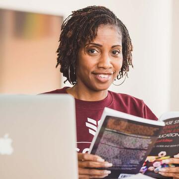 NCCU student looking up from her book, smiling