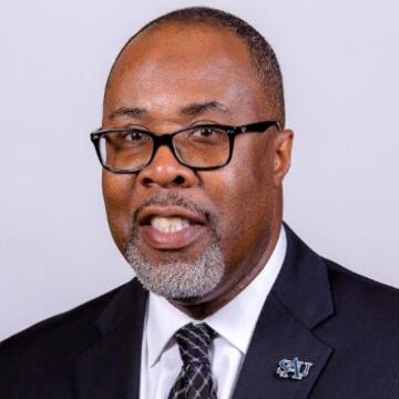 Board of Directors for NCCU Foundation Dr. Paul Andrew Norman has on a black suit with white tie.